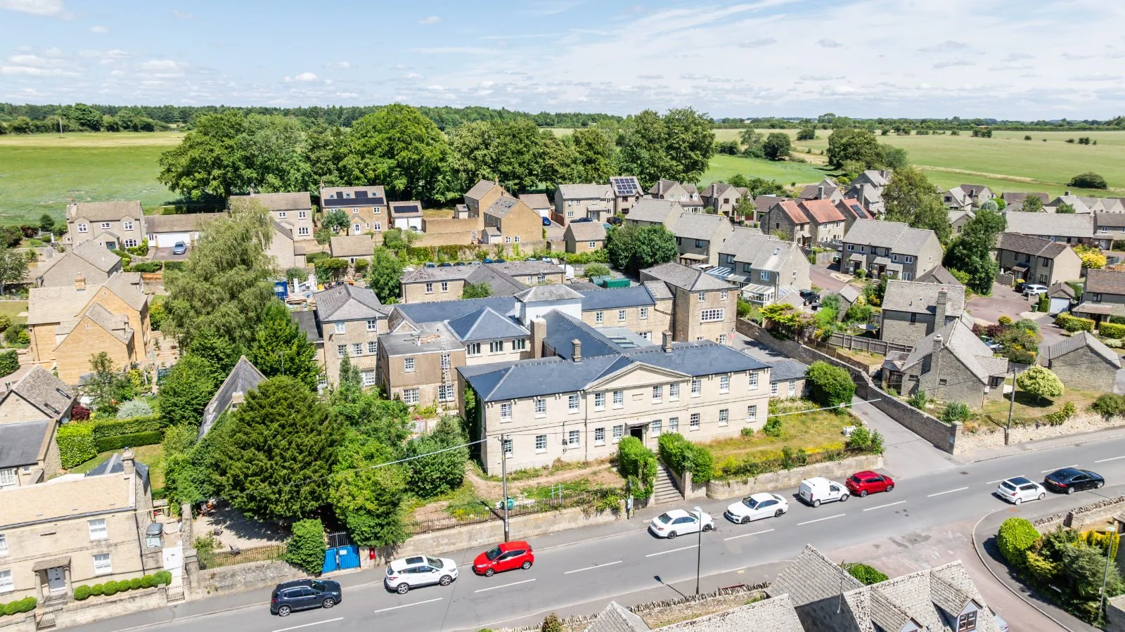 Aerial view looking across the High Street to the home and fields